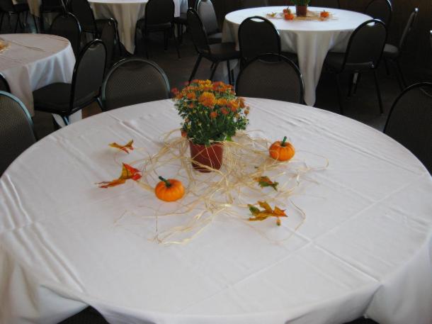 Tables consisted of orange chrysanthemums orange pumpkins preserved oak