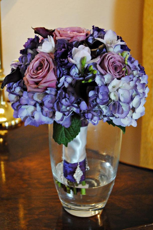  and dark purple mini calla lilies accented with purple and silver ribbon 