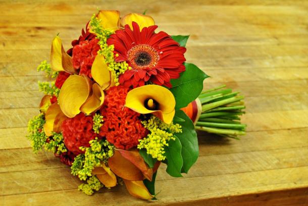 Bridal bouquet of orange celosia yellow with red tip mini calla lilies 