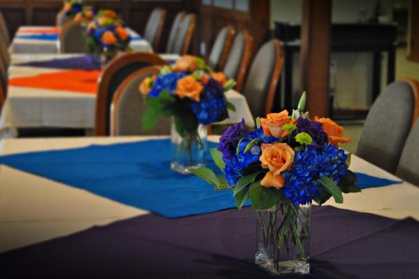 Reception centerpieces of blue hydrangeas orange 39Miracle 39 roses 