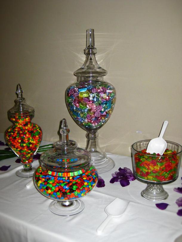 Reception candy table of varying size apothecary jars